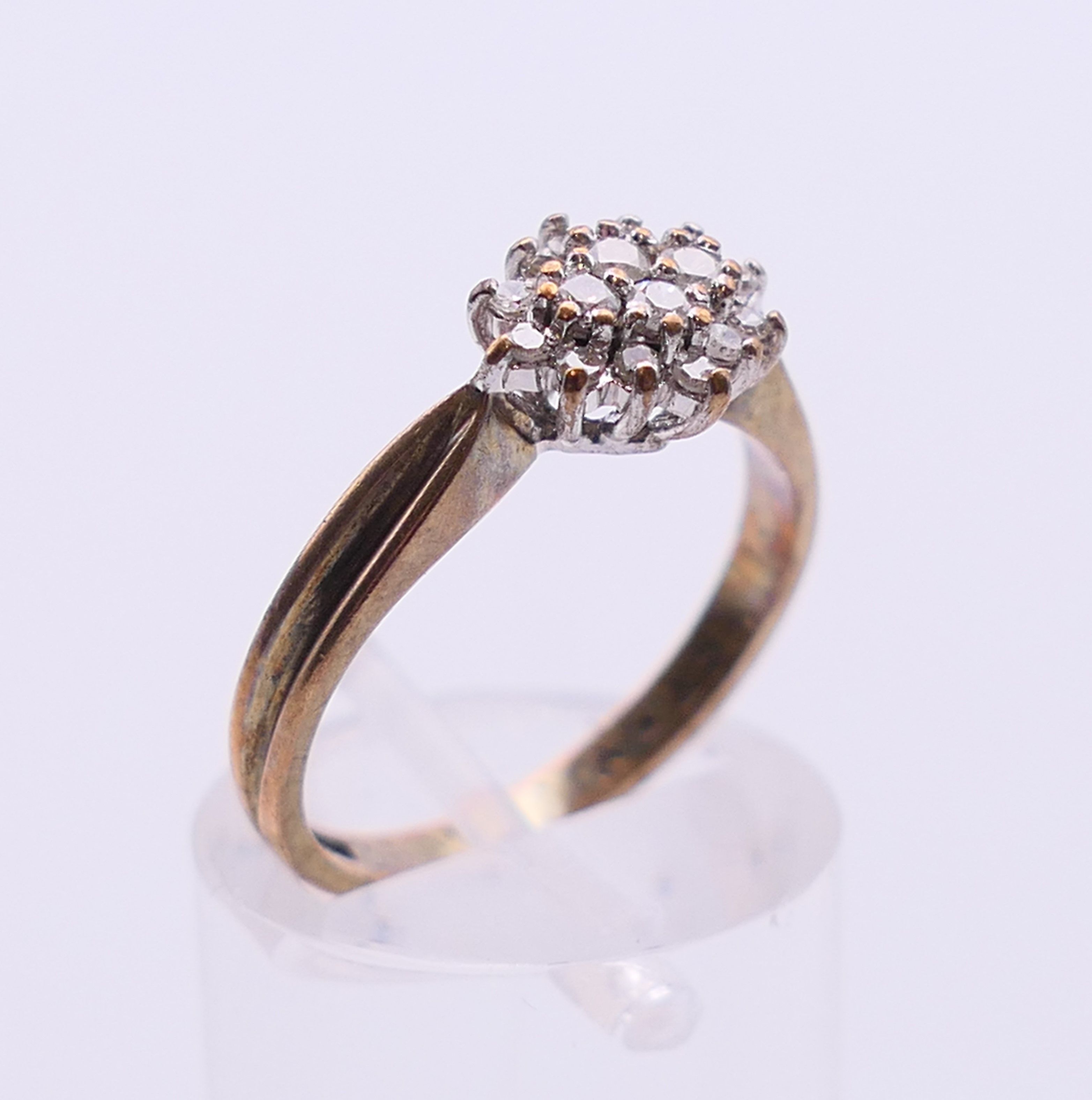 A 9 ct gold and diamond cluster ring. Ring size N/O. - Image 3 of 6