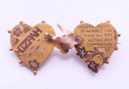 A 9 ct gold Mizpah two-heart brooch. 4 cm wide. 2.2 grammes total weight.