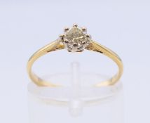 An 18 ct gold and platinum diamond solitaire ring. The claw set stone spreading to 0.25 carat.