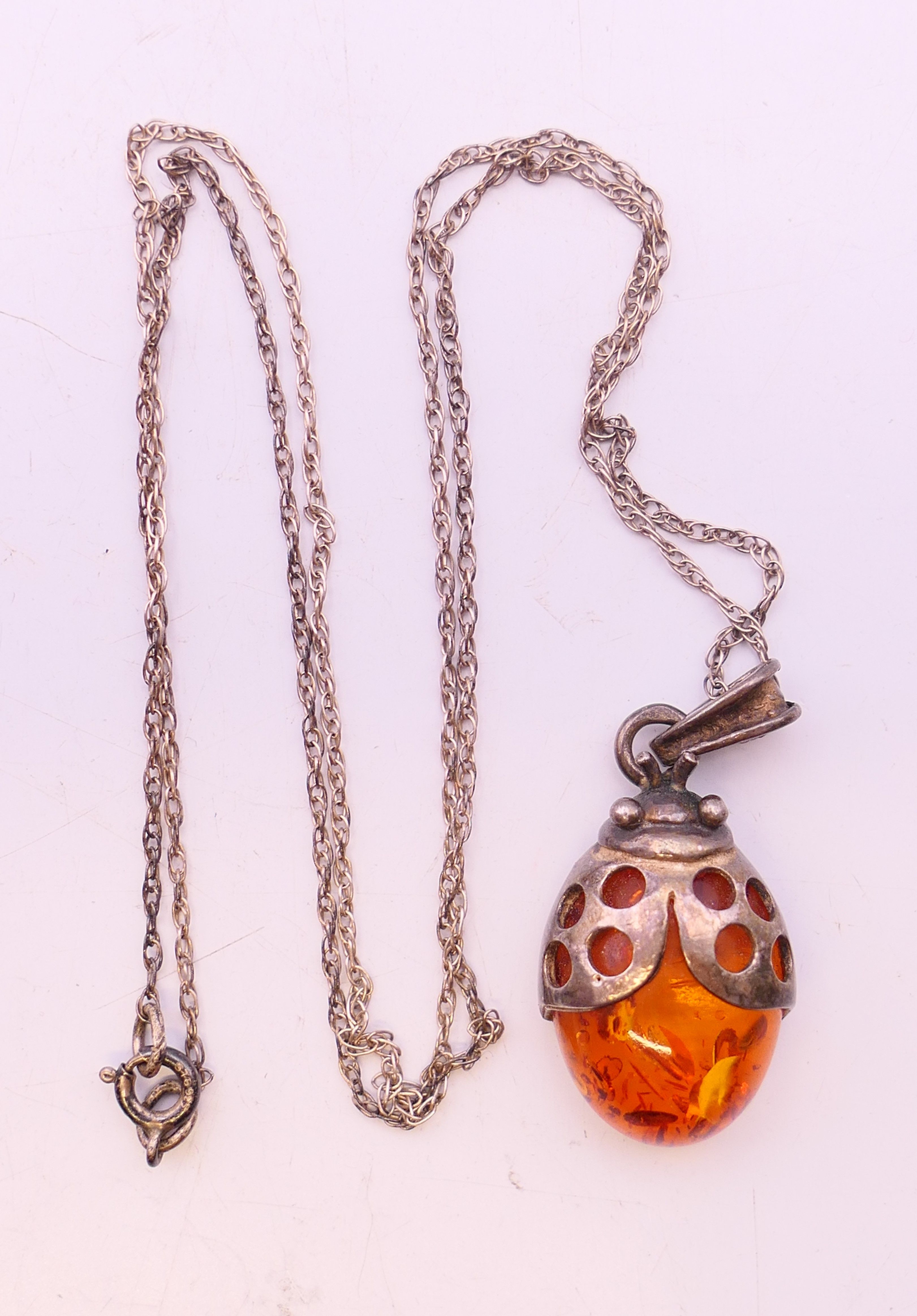 Four silver and amber items of jewellery. The largest pendant 5 cm high. - Image 3 of 11