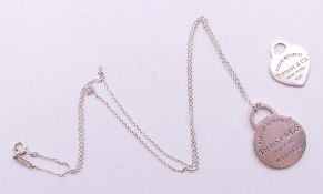 A Tiffany & Co silver necklace and two pendants in a Tiffany & Co box. The largest 2.5 cm high.
