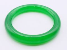 An apple green jade bangle. 6.25 cm inner diameter.