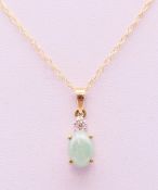 A 9 ct gold jade and diamond pendant on chain. The pendant 1 cm high.