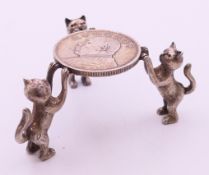 A cat coin stand. 4 cm high.
