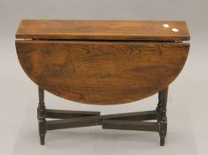 A small oak gate leg coffee table. 60 cm wide.