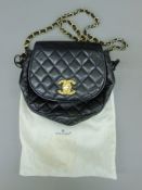 A 1990's Chanel black quilted half moon shoulder/crossover bag with leather and chain strap,