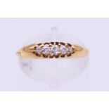 An 18 ct gold five-stone diamond ring. Ring size N.