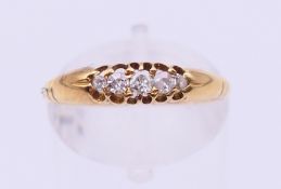 An 18 ct gold five-stone diamond ring. Ring size N.