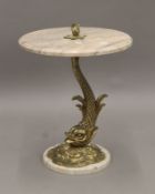 A vintage brass and marble side table, the stem formed as a dolphin. 54 cm high.