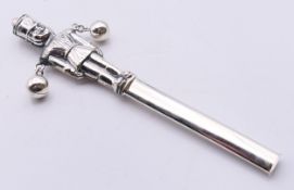 A sterling silver soldier form baby's rattle. 13.5 cm high.