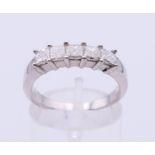 A 14 K white gold five-stone ring. Ring size O.