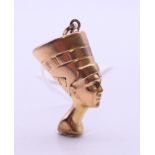 A 9 ct gold bust of Nefertiti pendant. 3.5 cm high. 6.2 grammes.