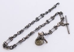 A silver pocket watch Albert chain with fob and watch key. 37 cm long.