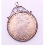 A Maria Theresa silver coin in pendant mount. Coin including mount 4.25 cm diameter.