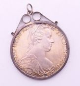 A Maria Theresa silver coin in pendant mount. Coin including mount 4.25 cm diameter.