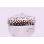 A 9 ct white gold wedding band. 3.4 grammes. Ring size L/M.