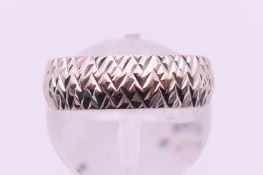 A 9 ct white gold wedding band. 3.4 grammes. Ring size L/M.