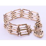 A 9 ct gold gate link bracelet with heart padlock. 18 cm long. 12.