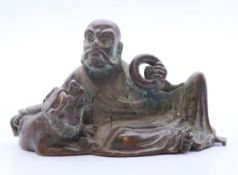 A Chinese bronze of a man with dog-of-fo. 6.75 cm long.