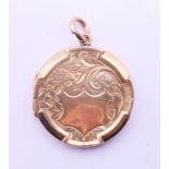 An antique 9 ct gold back and front hinged locket. 2.5 cm diameter.