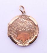 An antique 9 ct gold back and front hinged locket. 2.5 cm diameter.