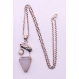 A silver and multi-stone abstract pendant on a silver chain. Pendant 5 cm high, chain 52 cm long.