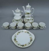 A Royal Doulton Larchmont porcelain tea set. The teapot 25 cm high.