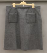 A Miu Miu grey woollen skirt, size 18, with branded hanger and dust cover.