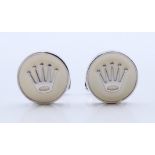 A pair of Rolex cufflinks with card certificate. 1.75 cm diameter.