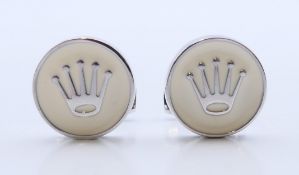 A pair of Rolex cufflinks with card certificate. 1.75 cm diameter.
