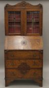 An early 20th century oak lead-glazed hall bureau bookcase. 73 cm wide.