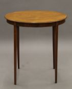 An Edwardian mahogany oval side table. 68.5 cm long.