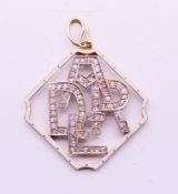 An antique white enamel and diamond 'DEAR' pendant. 3 cm high. 4.8 grammes total weight.