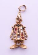A 9 ct gold gem-set clown pendant. 2.5 cm high. 2.2 grammes total weight.