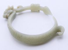 A celadon jade dragon bangle. 12 cm high.