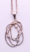 A silver and cubic zirconia pendant on a silver chain. Pendant 3 cm high, chain 44 cm long.