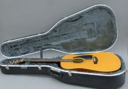 An Ibanez Performance acoustic guitar in a case, two guitar stands and a music stand.