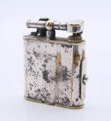 A 1920's Dunhill cigarette lighter. 5.25 cm high.
