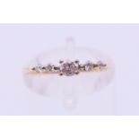 An 18 ct gold five-stone diamond ring. Ring size J.