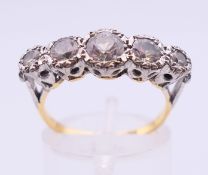 An 18 ct gold five stone ring. 4 grammes. Ring size N/O.