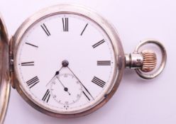 A silver half hunter pocket watch. 5 cm diameter.
