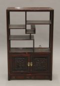 A Chinese wooden side cabinet. 40 cm wide.