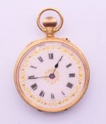 An 18 ct gold pocket watch with white dial and engraved decoration to case. 3.25 cm diameter.