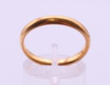 A 22 ct gold wedding band. Ring size P. 4.6 grammes.