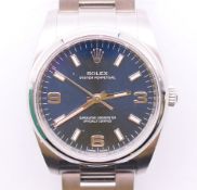 A boxed Rolex Oyster Perpetual gentleman's stainless steel wristwatch with blue dial,