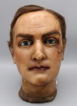 Early C20th male wax mannequin head, with real hair, glass eyes and painted face, c1930s, H25cm