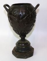 C19th bronze twin handled urn, relief decorated with leaves and berries, H27.5cm