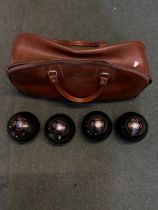 Four Thomas Taylor bowling woods with original bag, size 4