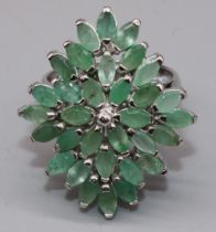 Silver cluster ring set with thirty two marquise cut emeralds in claw settings, on plain shank,