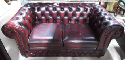 Thomas Lloyd red leather upholstered two-seat Chesterfield sofa, deep buttoned back and arms with